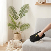 PawGroom grooming glove lifestyle shot with cat and sofa