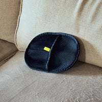 Furniture mitt lifting pet hair off a beige couch