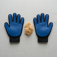 PawGroom grooming glove pair — blue silicone gloves with collected pet fur